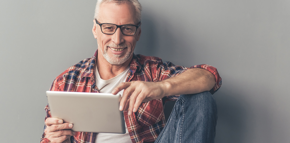 Man with grey hair using a tablet