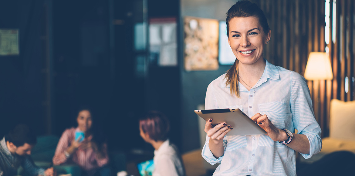 Smiling Trainer Hero Smiling woman with tablet